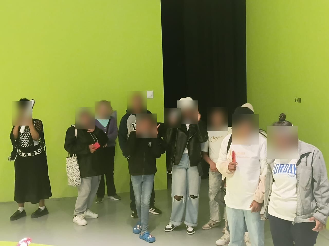 The Kezlei group together inside a colourful museum gallery